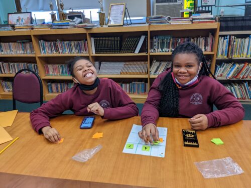 Young student practicing problem-solving skills with encouragement from Y-Math tutor